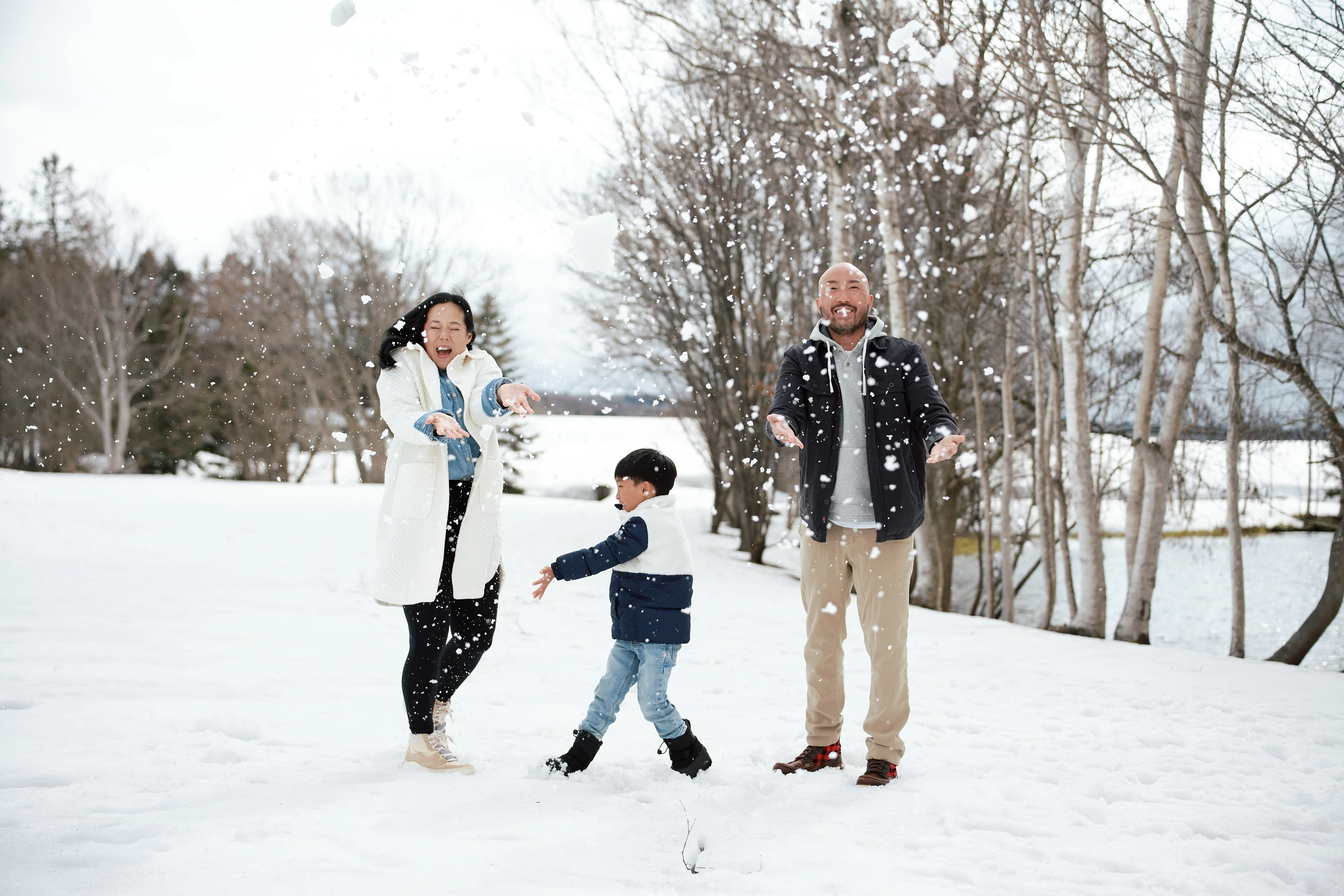 Couple in fresh snow with Mt Yotei behind